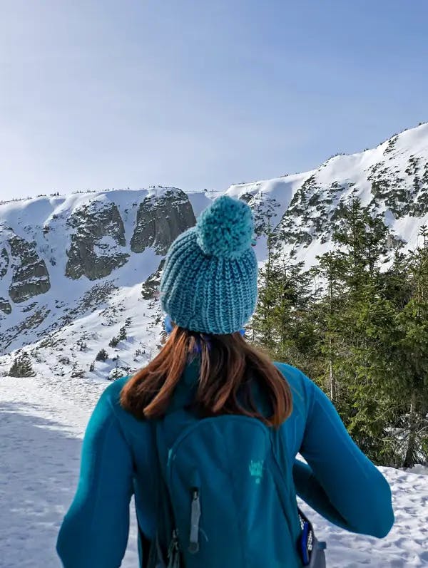woman-with-blue-hat-in-snowy-mountains-of-park-city