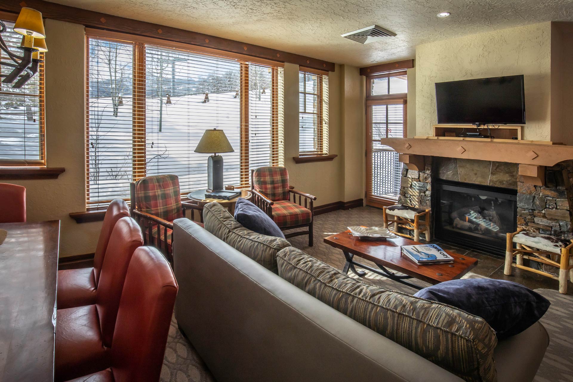 living-room-with-television-fireplace-with-window-to-mountains-of-park-city-in-the-miners-club